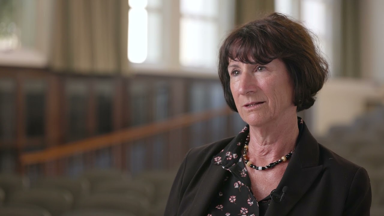 Dr. Penelope Quintana sitting in SDSU building