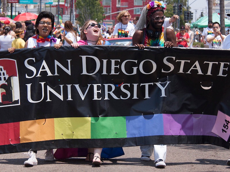 students at pride with an sdsu sign