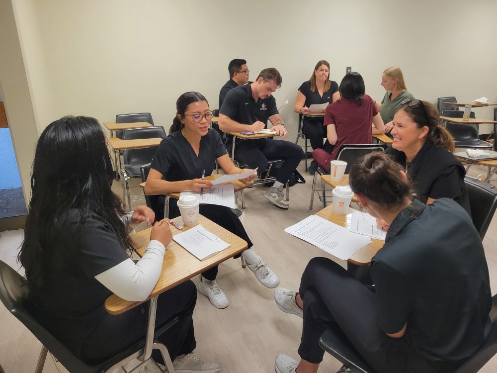 Student and Faculty applying device onto students back