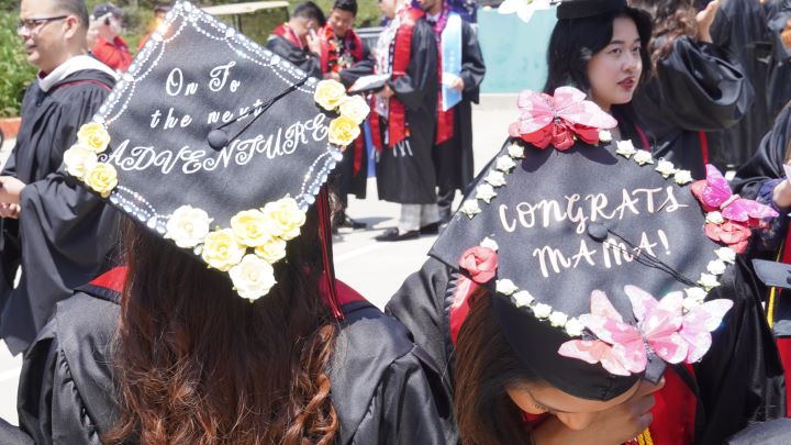 Graduating Students showing off their custom Caps for graduation