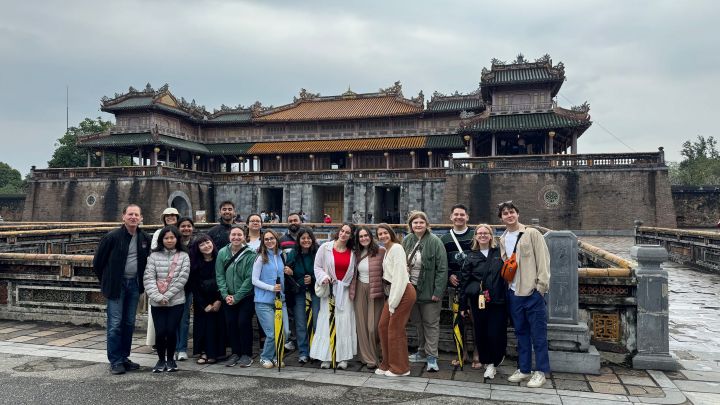 Group of Students standing in front of Vietnamese Temple